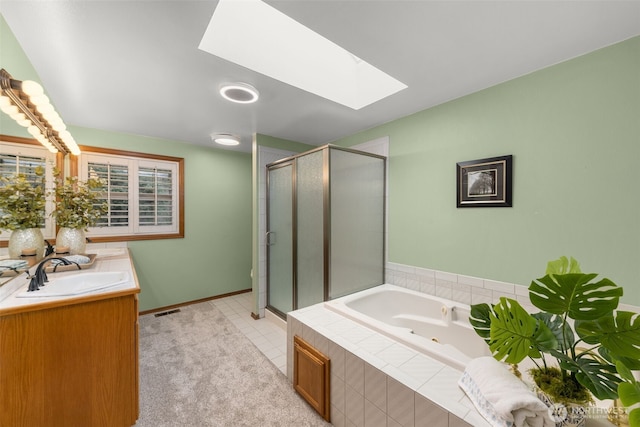 full bath with visible vents, a shower stall, a skylight, a tub with jets, and vanity