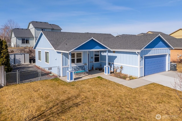 view of front of property with fence, driveway, a shingled roof, a front lawn, and a garage