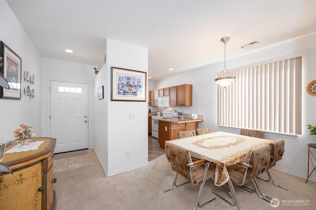 dining room with recessed lighting, baseboards, light carpet, and visible vents