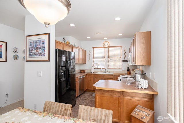 kitchen with white appliances, a peninsula, recessed lighting, a sink, and light countertops