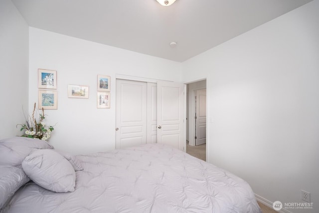 bedroom featuring a closet and light colored carpet