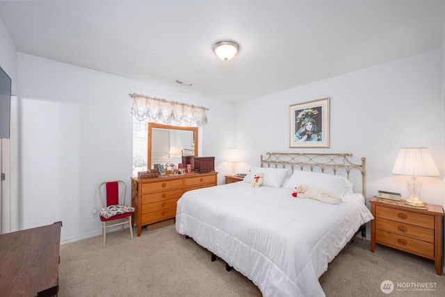 carpeted bedroom with baseboards and visible vents