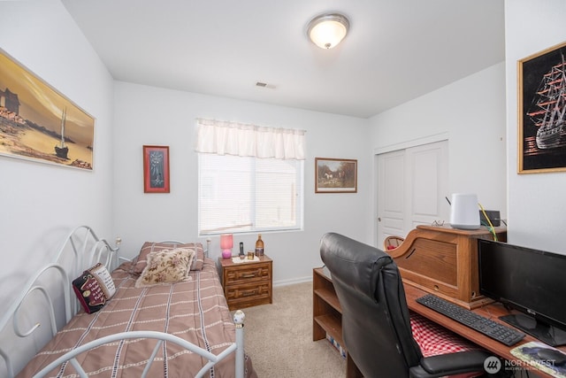 carpeted bedroom with visible vents and a closet