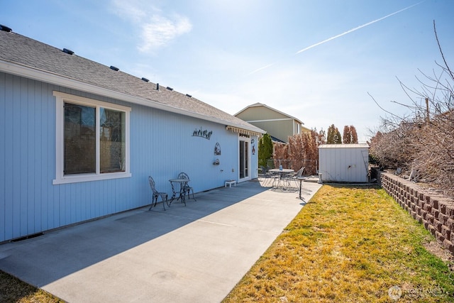 view of yard featuring visible vents, an outbuilding, fence, a shed, and a patio area