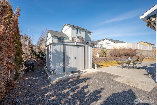 view of shed featuring fence