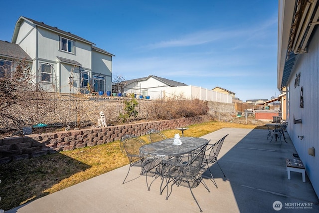 view of patio / terrace with a residential view, outdoor dining space, and a fenced backyard