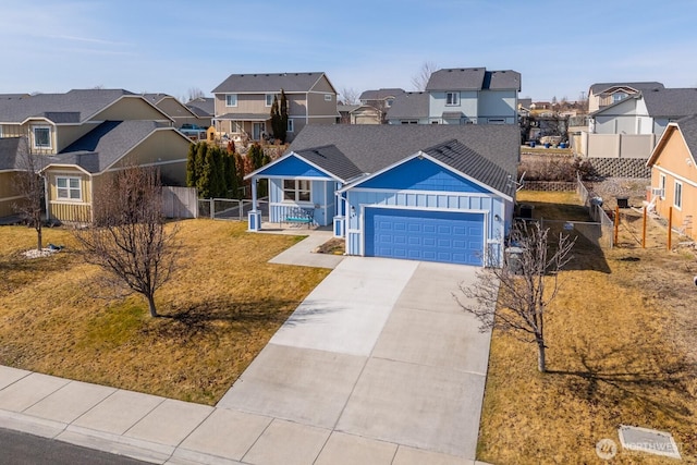 view of front of house featuring a residential view, board and batten siding, driveway, and fence