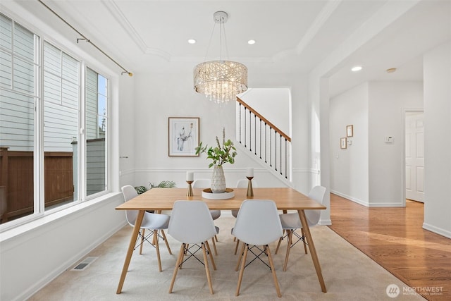 dining area with a tray ceiling, recessed lighting, visible vents, and ornamental molding