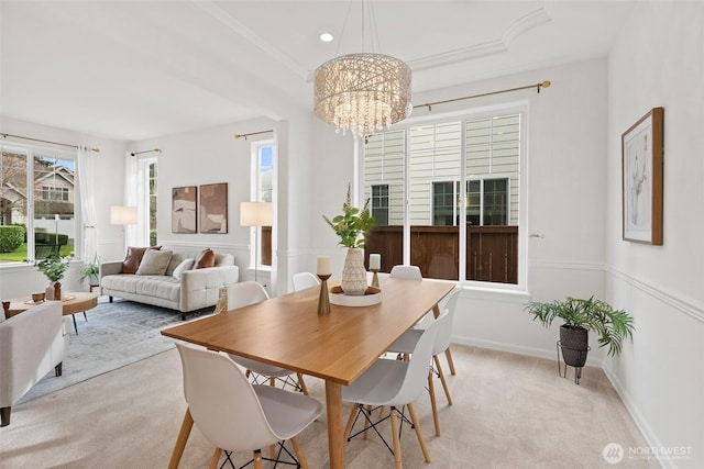 dining area with crown molding, baseboards, light carpet, recessed lighting, and a notable chandelier