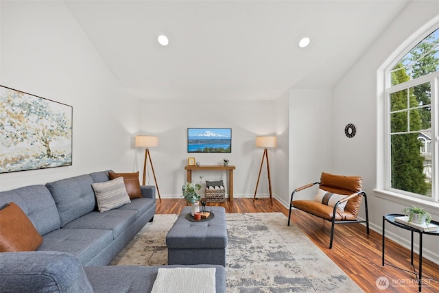 living area featuring recessed lighting, baseboards, and wood finished floors