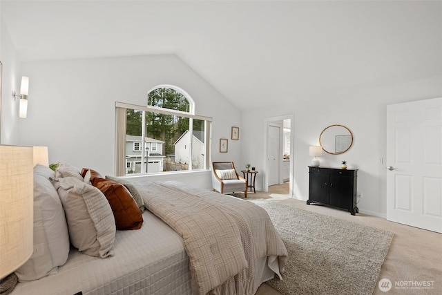 bedroom with light carpet and high vaulted ceiling