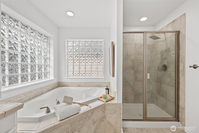 full bath with a garden tub, recessed lighting, and a stall shower