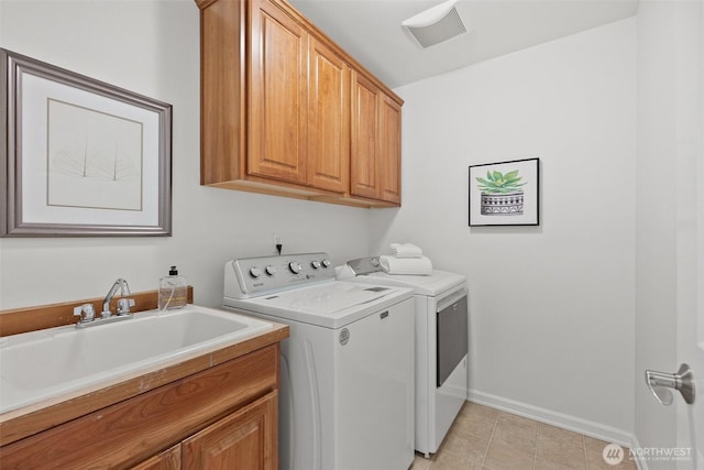 laundry room featuring visible vents, baseboards, washer and dryer, cabinet space, and a sink