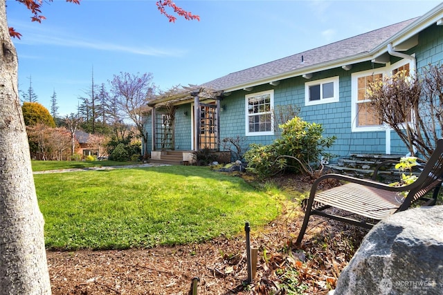 6065 Central Ave, Anacortes, WA 98221 - rear view of house with a yard and a shingled roof