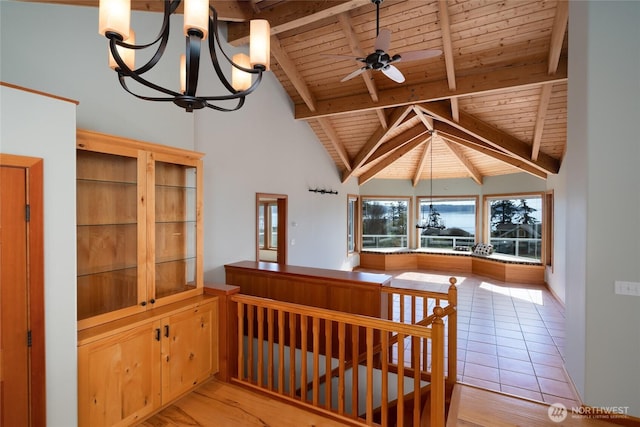 6065 Central Ave, Anacortes, WA 98221 - interior space featuring wood ceiling, beam ceiling, high vaulted ceiling, light wood finished floors, and ceiling fan with notable chandelier