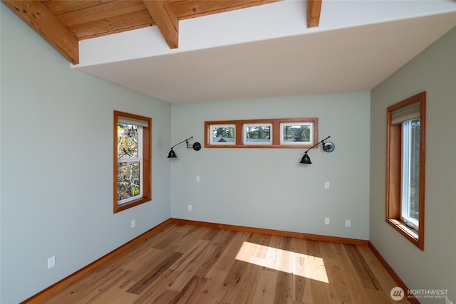 6065 Central Ave, Anacortes, WA 98221 - unfurnished room with beam ceiling, baseboards, light wood-style floors, and wood ceiling
