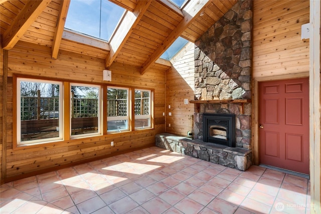 6065 Central Ave, Anacortes, WA 98221 - unfurnished living room featuring a skylight, wooden walls, beamed ceiling, and wood ceiling