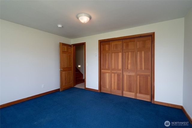 6065 Central Ave, Anacortes, WA 98221 - unfurnished bedroom featuring a closet, baseboards, and carpet