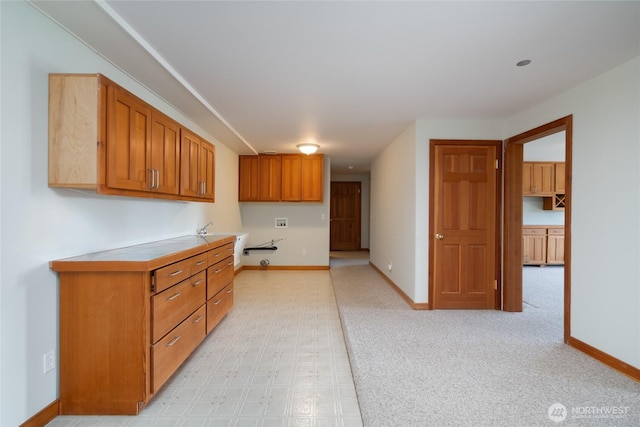 6065 Central Ave, Anacortes, WA 98221 - kitchen featuring light countertops, baseboards, and brown cabinetry