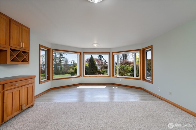 6065 Central Ave, Anacortes, WA 98221 - interior space with light carpet, light wood-style floors, and baseboards