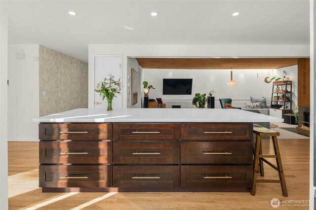 bar with light wood finished floors and recessed lighting