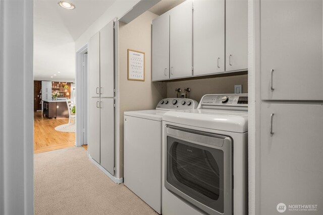 washroom with recessed lighting, cabinet space, light colored carpet, and separate washer and dryer