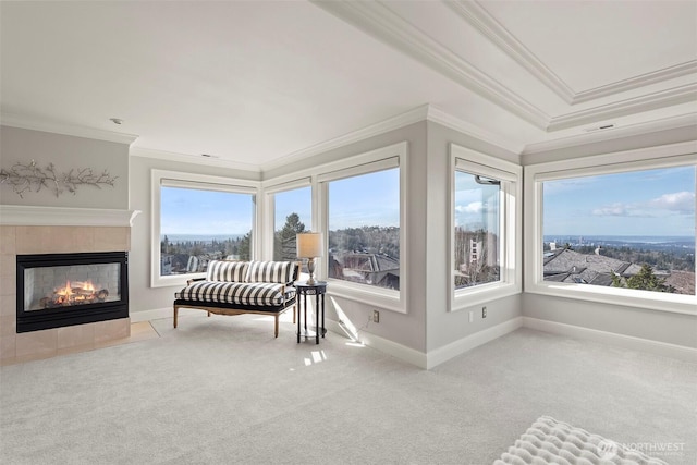 sunroom with a tiled fireplace, visible vents, and a wealth of natural light