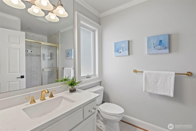 bathroom with crown molding, baseboards, toilet, a stall shower, and vanity