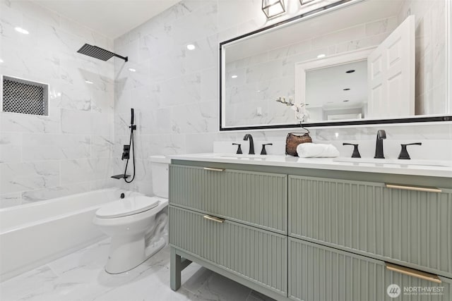 full bathroom featuring a sink, tile walls, toilet, and marble finish floor