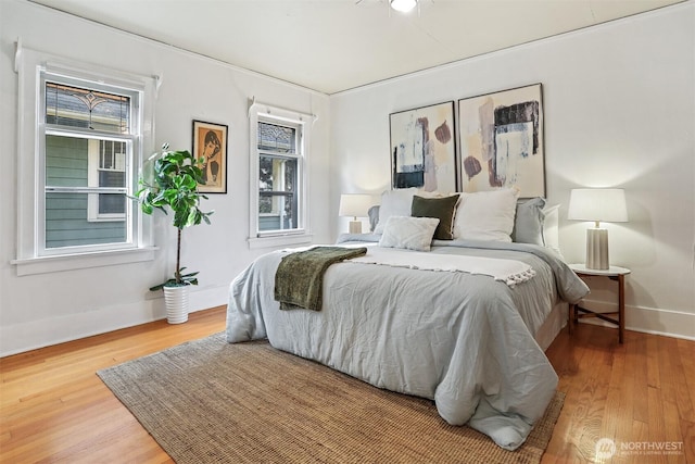 bedroom with baseboards and wood finished floors