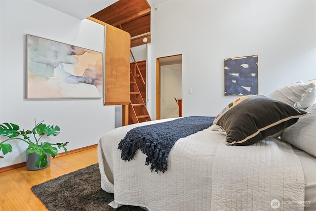 bedroom with baseboards and wood finished floors