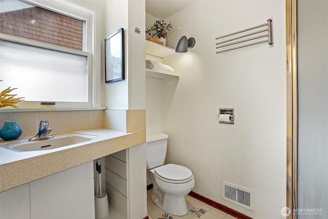 half bath featuring tile patterned floors, visible vents, toilet, and vanity