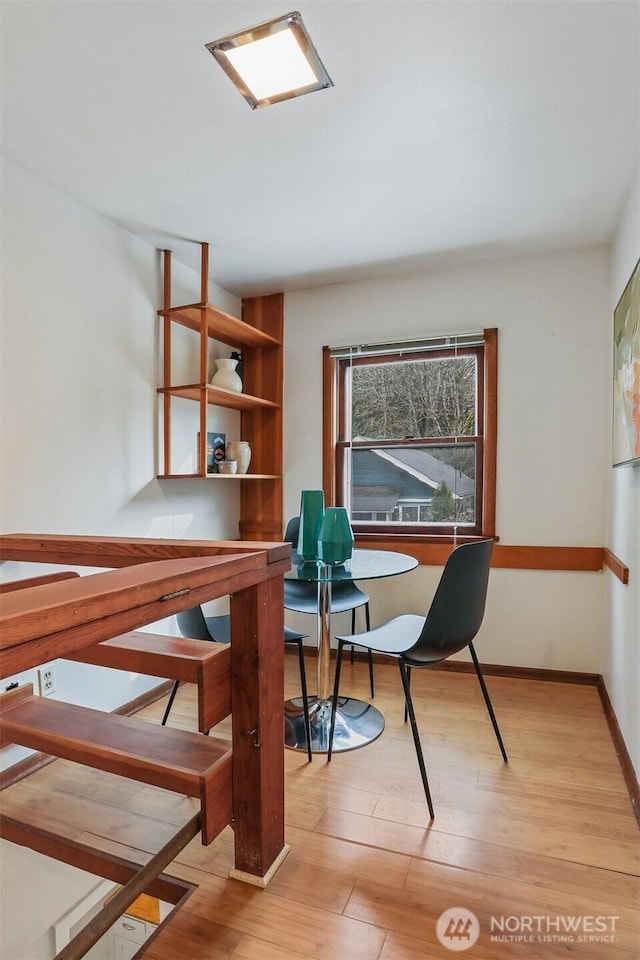 office area featuring baseboards and light wood-type flooring