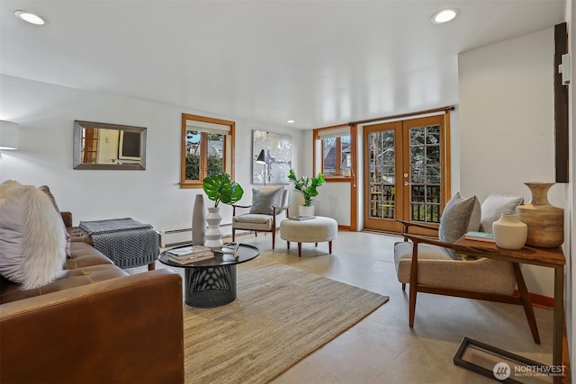 living area featuring recessed lighting, a baseboard heating unit, and baseboards