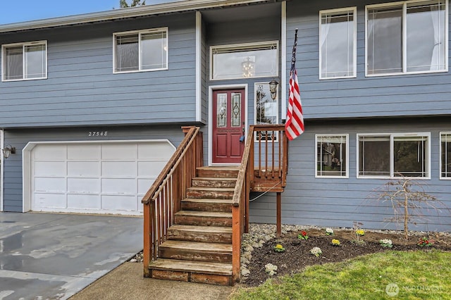 view of exterior entry featuring an attached garage