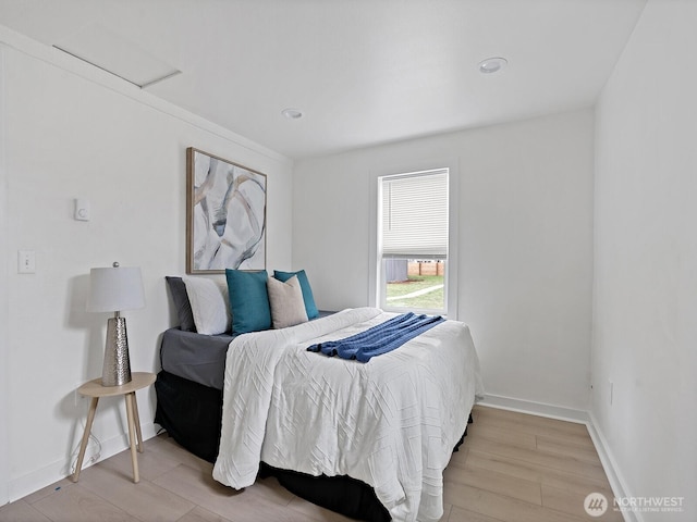 bedroom featuring light wood-type flooring and baseboards