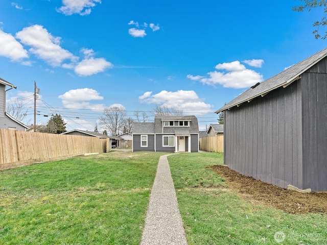 view of yard with an outbuilding and a fenced backyard