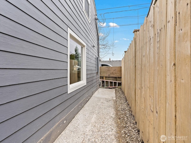 view of home's exterior with fence