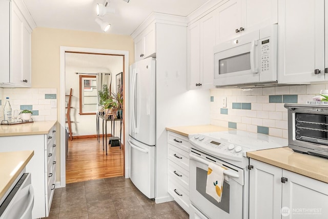 kitchen featuring white appliances, white cabinetry, a toaster, and light countertops