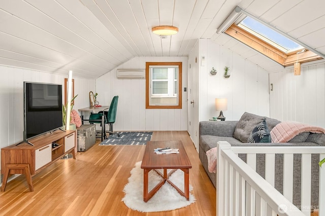 living area with lofted ceiling with skylight, light wood-style floors, wooden ceiling, and a wall unit AC