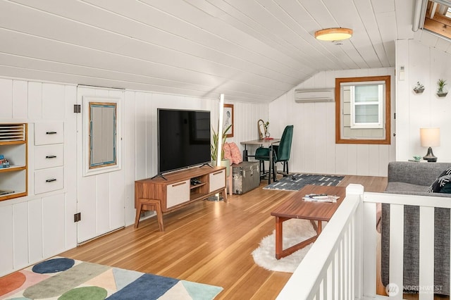 living room with wooden ceiling, a wall mounted air conditioner, light wood-type flooring, and vaulted ceiling