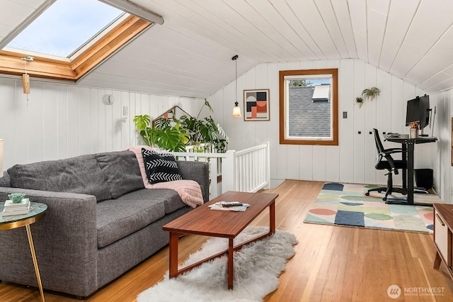 living area featuring wood-type flooring, wood ceiling, and vaulted ceiling with skylight