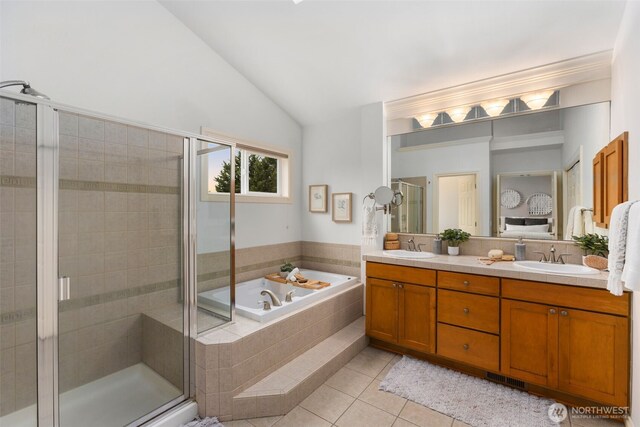 full bathroom with a garden tub, a sink, vaulted ceiling, a shower stall, and tile patterned floors