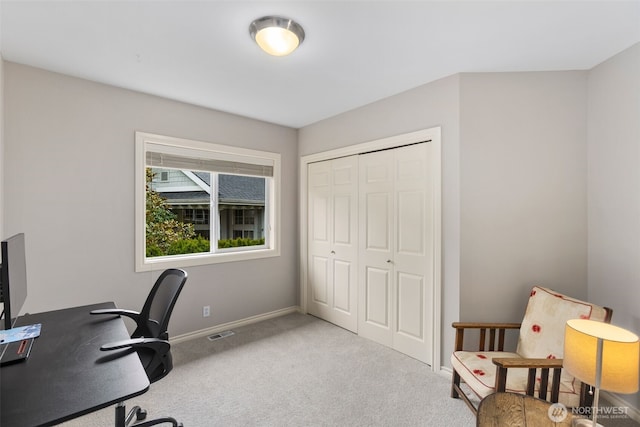 carpeted home office with visible vents and baseboards