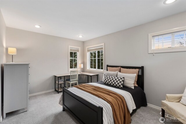 carpeted bedroom featuring recessed lighting, multiple windows, and baseboards