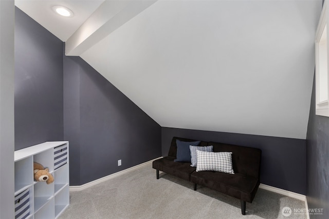 sitting room featuring vaulted ceiling, baseboards, and carpet floors