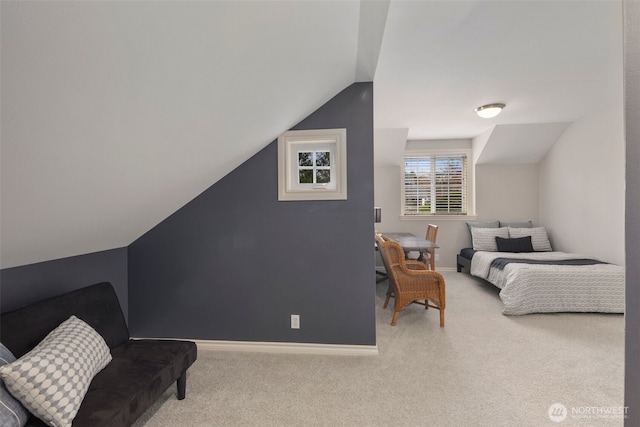 bedroom with baseboards, carpet, and lofted ceiling