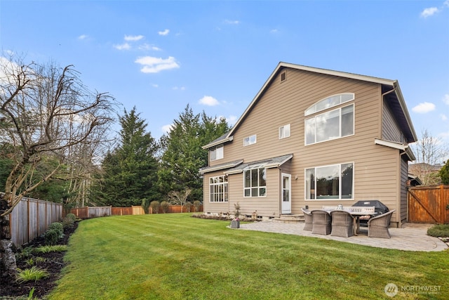 rear view of property with a fenced backyard, a lawn, entry steps, and a patio