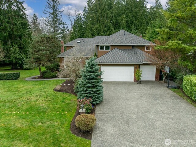 view of front of property featuring a chimney, driveway, a shingled roof, and a front lawn