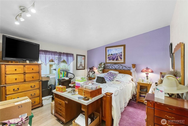 bedroom featuring vaulted ceiling and light wood-style flooring